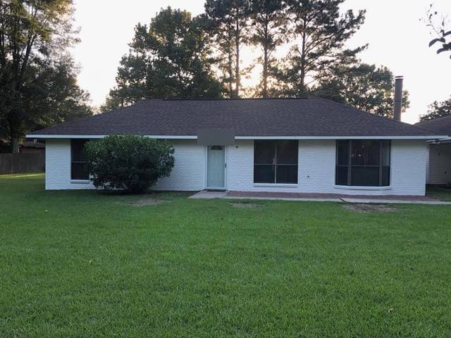 A white-painted brick ranch at dusk