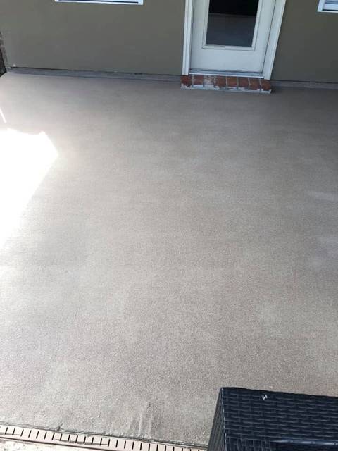 A back patio slab with a speckled tan coating