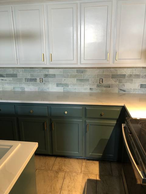 Teal lowers and a marble subway backsplash, up close