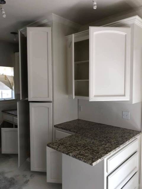 White-painted cabinets with arched raised panels