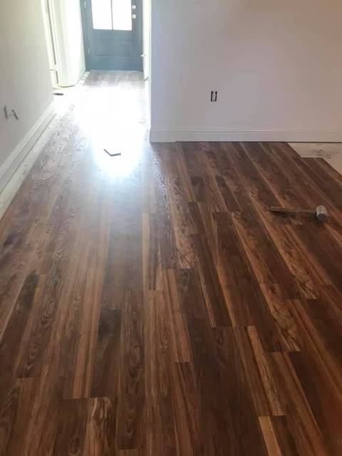 New plank flooring laid through a room into a hall
