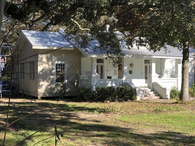 A craftsman bungalow with scaffolding up at the side